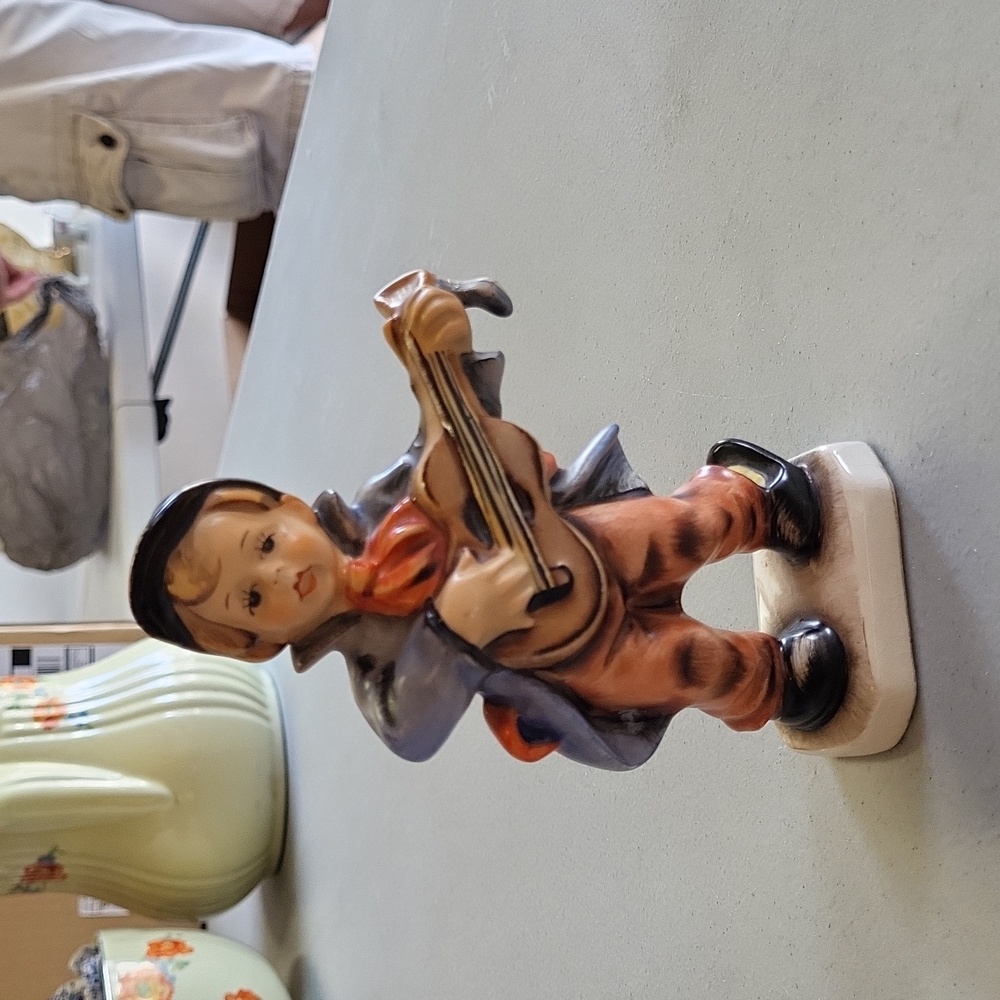Boy playing guitar figurine